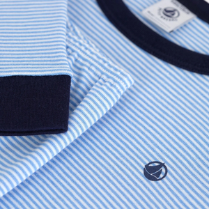 Close-up of a blue and white striped shirt with a brand logo on a white background