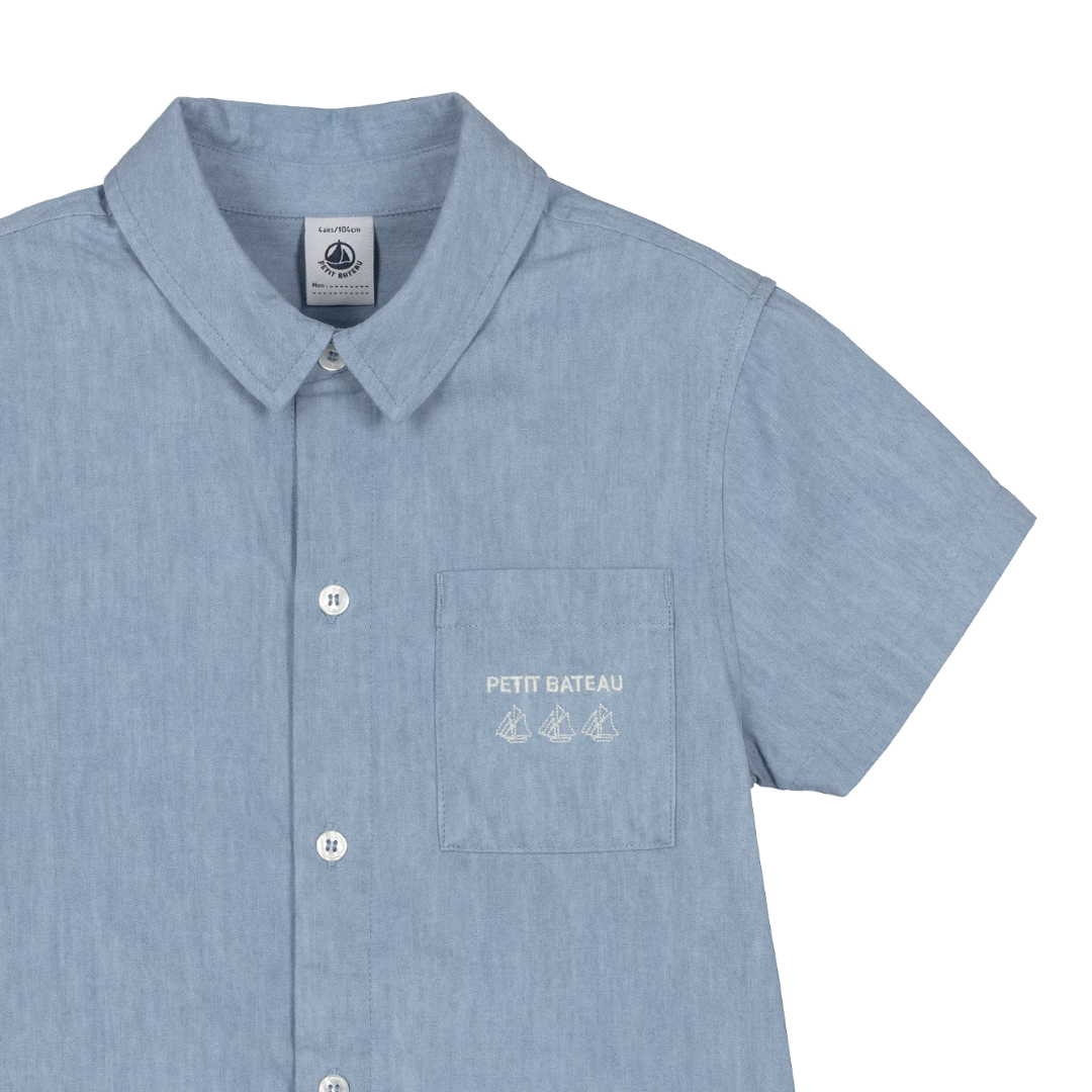 Blue shirt with a pocket and 'Petit Bateau' logo on a white background