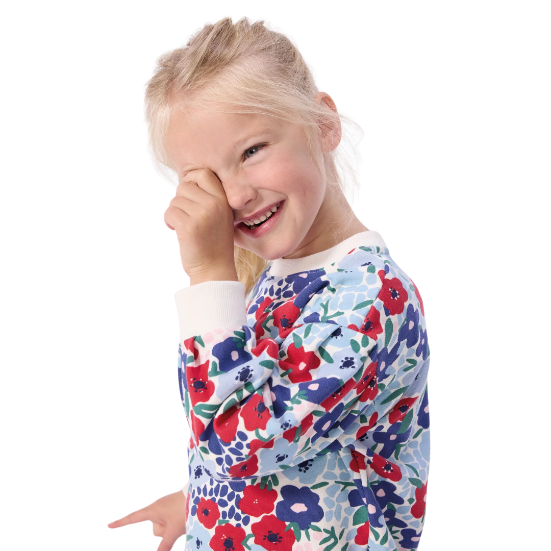Child wearing a floral-patterned shirt on a white background
