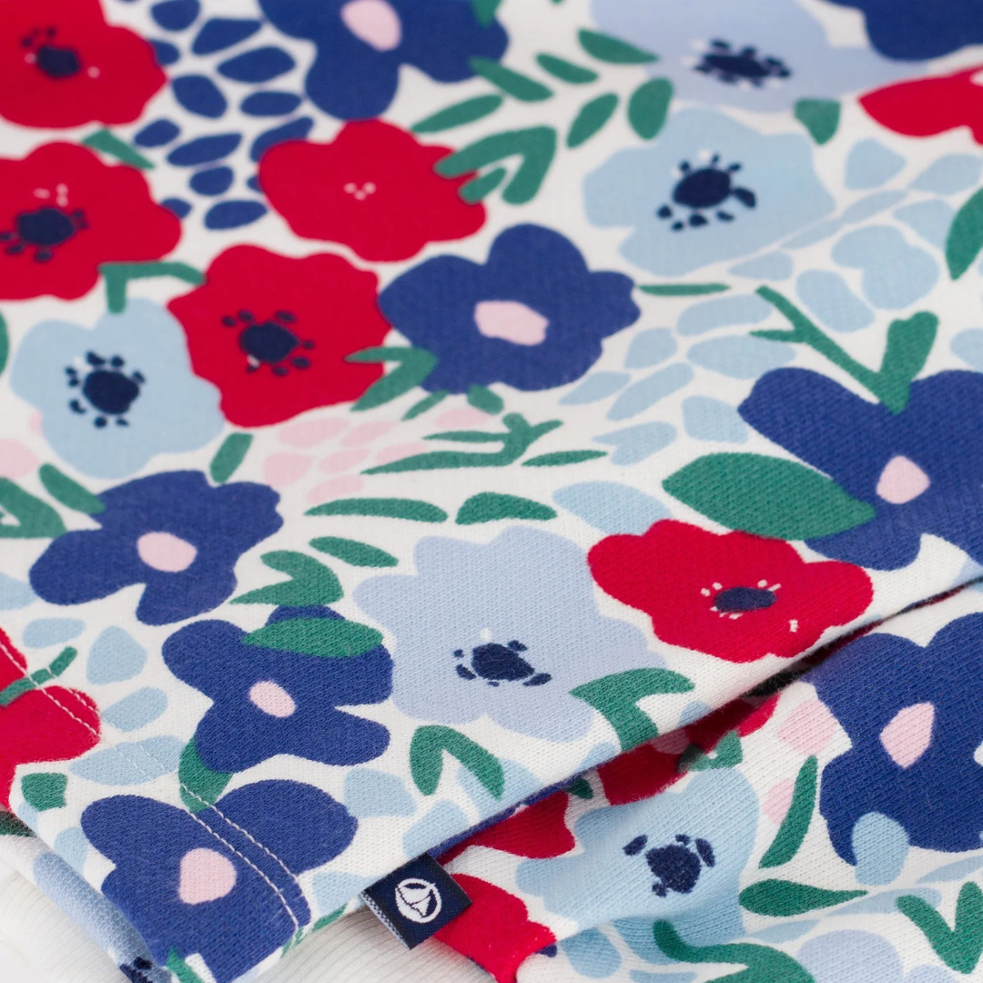 Floral fabric with red, blue, and green flowers on a white background