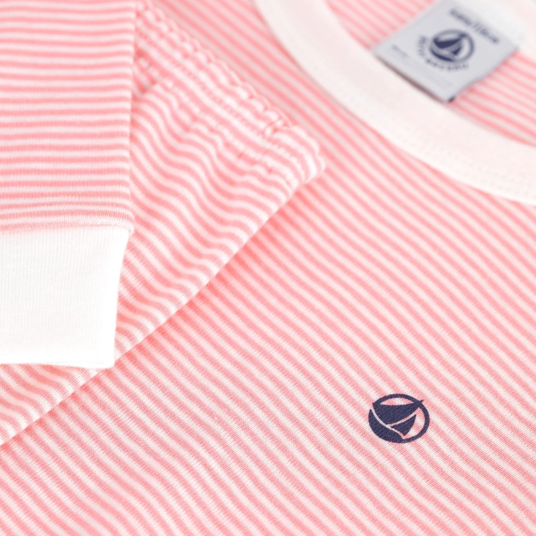 Pink and white striped shirt with a logo on a white background