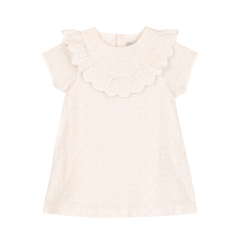 White dress with ruffled details on a white background