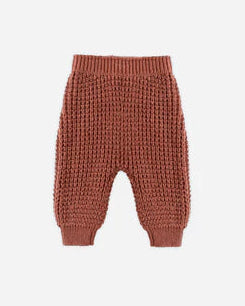 Brown knitted baby pants on a white background