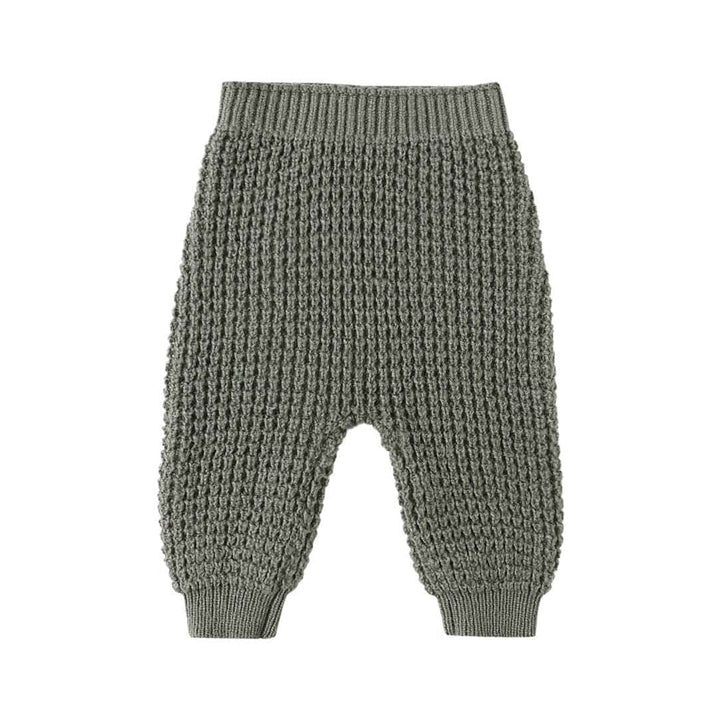 Knitted baby pants on a white background