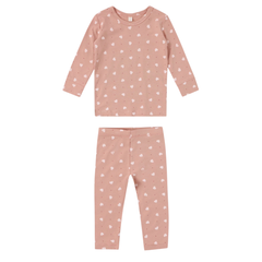 Pink children's pajama set with white heart patterns on a white background