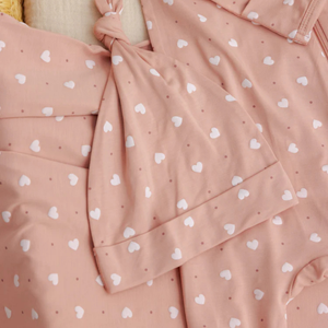 Pink fabric with white heart patterns