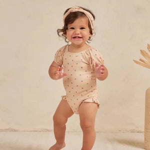 Floral-patterned bib on a white background