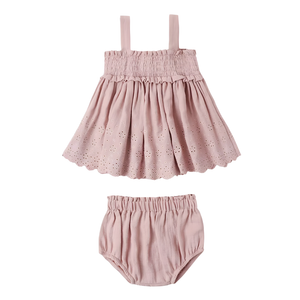 Pink baby dress with straps and matching bloomers on a white background