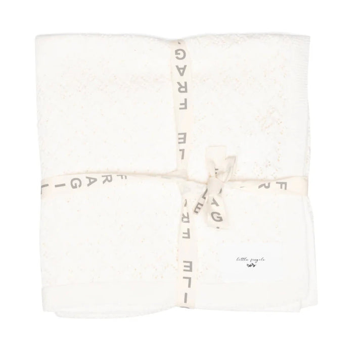 White blanket with gold text on a white background