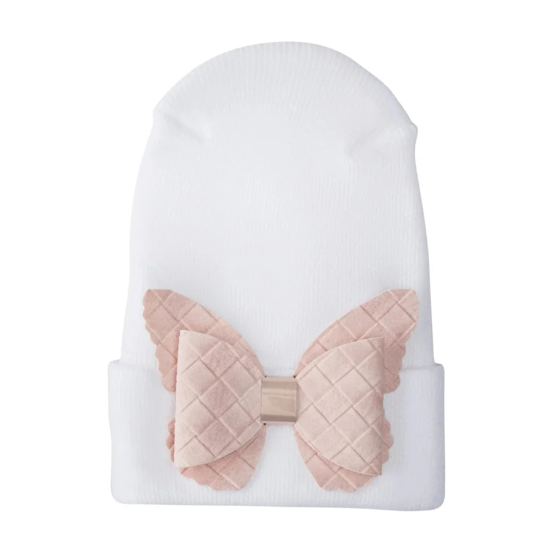 A front view of the Adora fuzzy butterfly newborn hospital hat cream