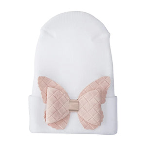 A front view of the Adora fuzzy butterfly newborn hospital hat cream