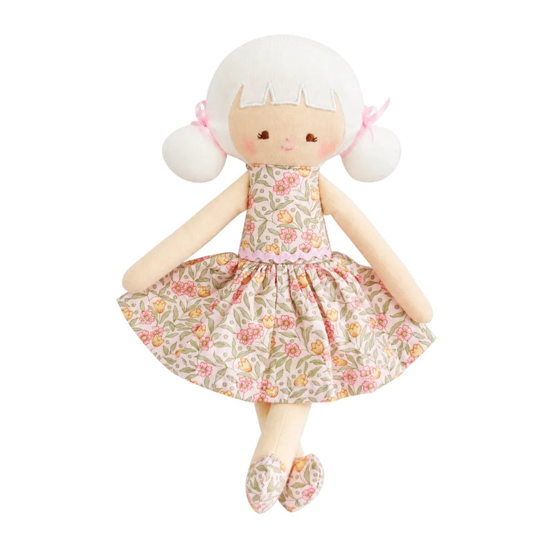 A flat-lay view of the Alimrose Audrey 26cm doll in blossom lily pink.