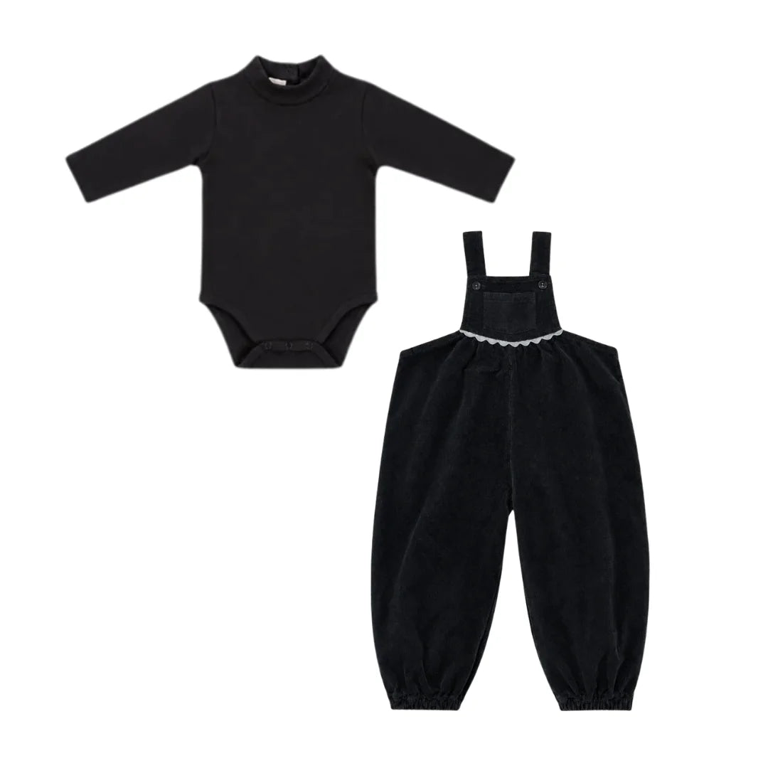 A front view of the Ann of Nan black toddler overall and onesie set.
