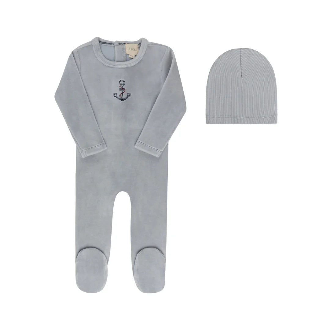 A front view of the Aurora cross-stitch footie and matching beanie set in blue.