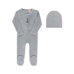 A front view of the Aurora cross-stitch footie and matching beanie set in blue.