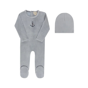 A front view of the Aurora cross-stitch footie and matching beanie set in blue.