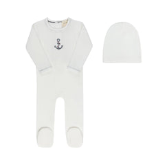 A front view of the Aurora cross-stitch footie and matching beanie set in ivory.