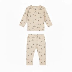 A long-sleeve baby t-shirt in cream-colored cotton with a small teddy bear and block print pattern, shown flat on a white background.