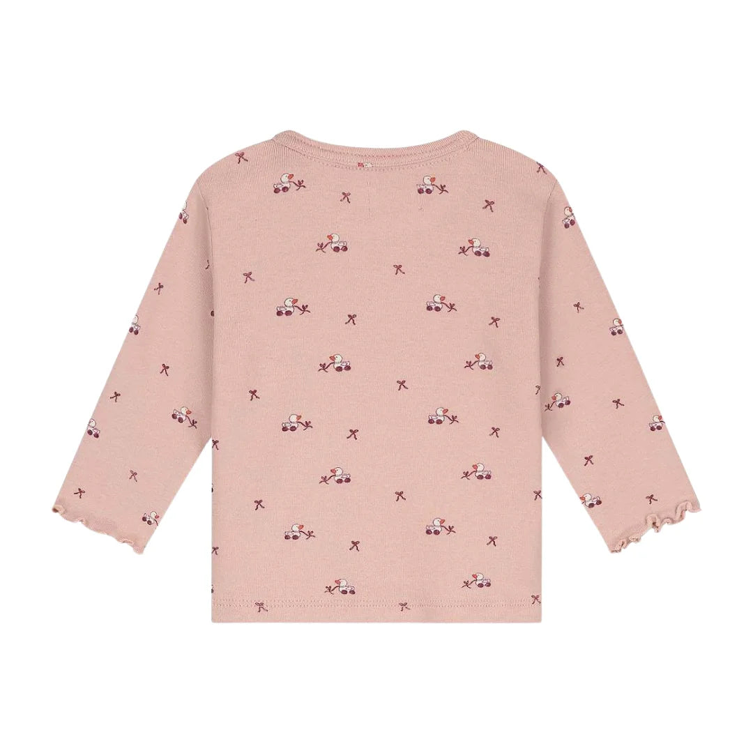 A pink long-sleeve knit top for toddlers, featuring a repeating pattern of small pink and purple flowers with star accents, displayed against a solid white background.