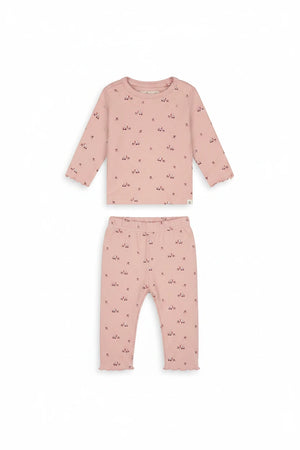 A pink long-sleeve baby top with a small all-over pattern of tiny red bows and white star-shaped embellishments, displayed flat against a solid white background.