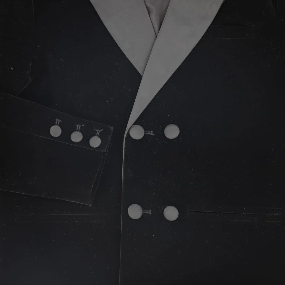A high-resolution close-up of the plush velvet lapel and crisp taffeta texture.