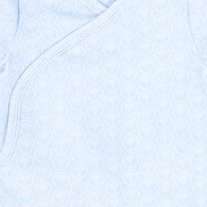 A high-resolution close-up of the delicate floral print and soft organic fabric texture.