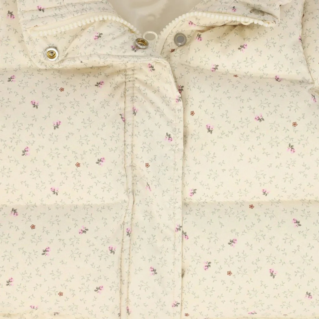 A high-resolution close-up of the vibrant floral pattern and quilted puffer texture.