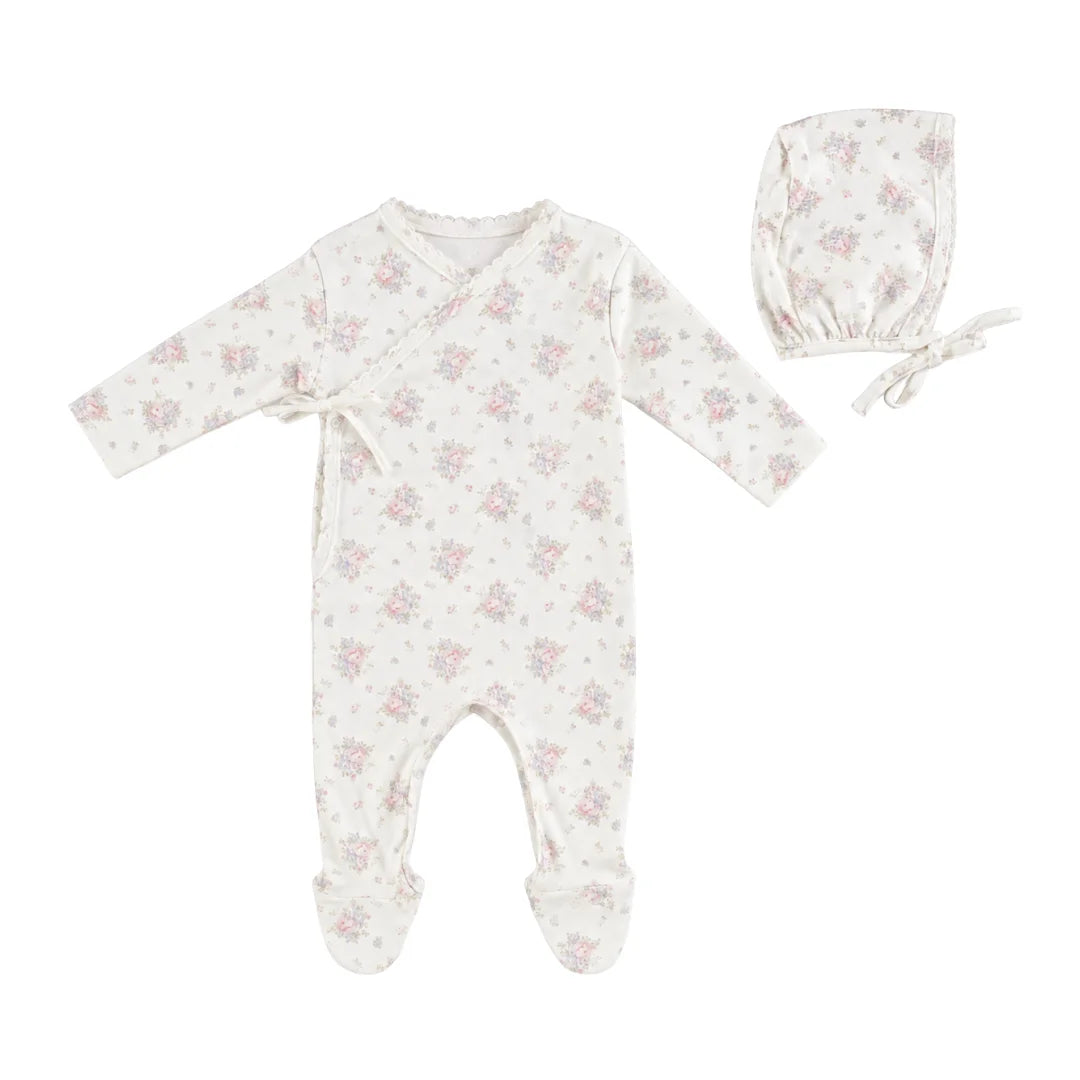 A front view of the Bebe Organic Amora Blooms newborn wrap footie and bonnet set.