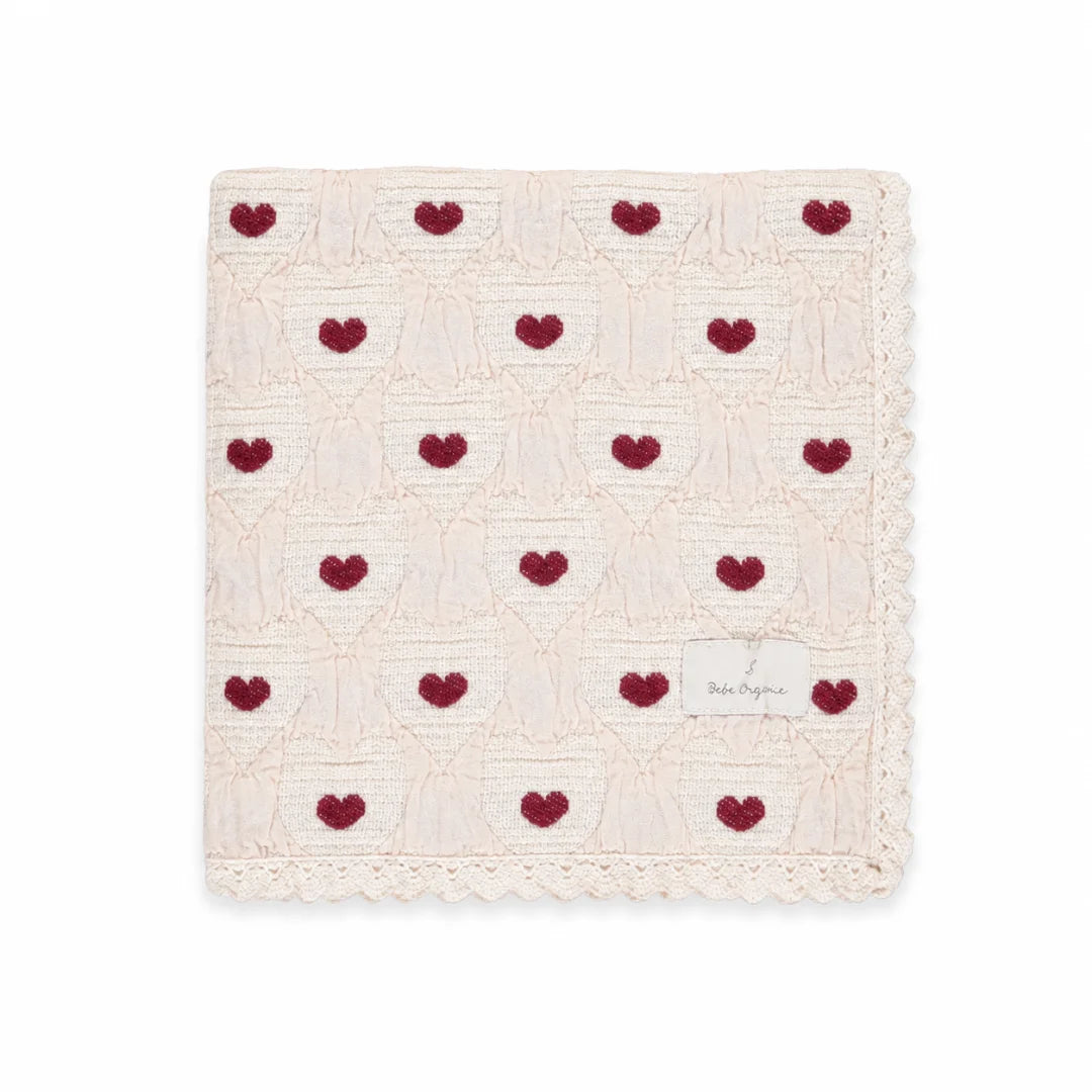 A neatly folded presentation showcasing the heart knit pattern and texture.