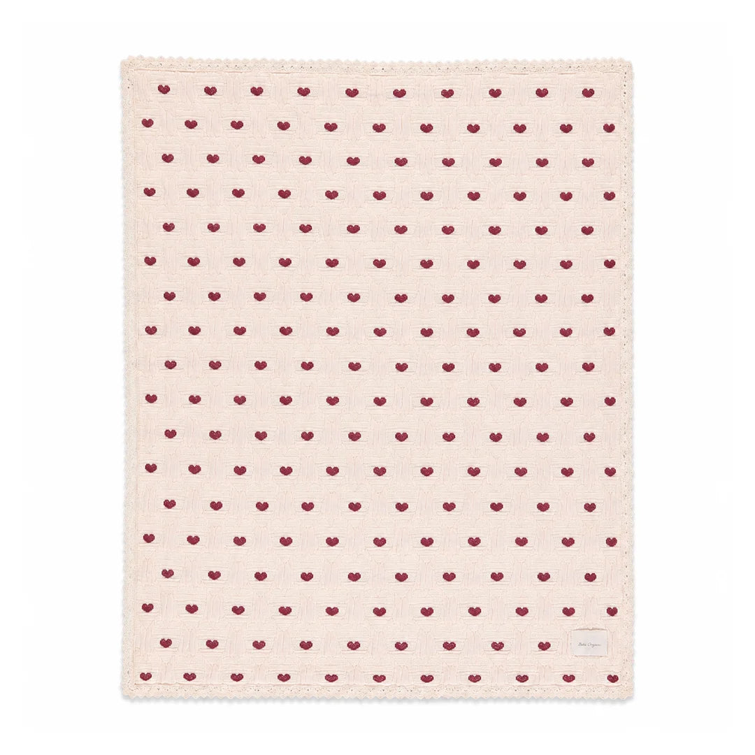 A front view of the Bebe Organic heart motif organic cotton baby blanket.