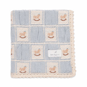 A neatly folded presentation showcasing the patchwork design and lace edges blue