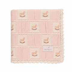 A neatly folded presentation showcasing the patchwork design and lace edges mauve