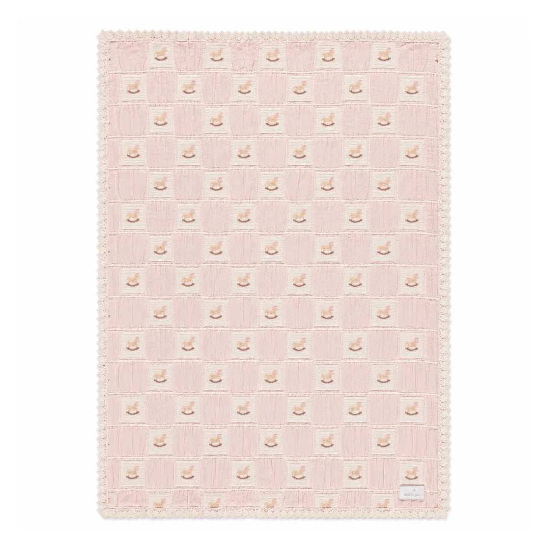 A front view of the Bebe Organic rocking horse patchwork organic cotton baby blanket mauve