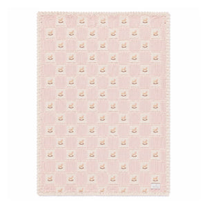 A front view of the Bebe Organic rocking horse patchwork organic cotton baby blanket mauve