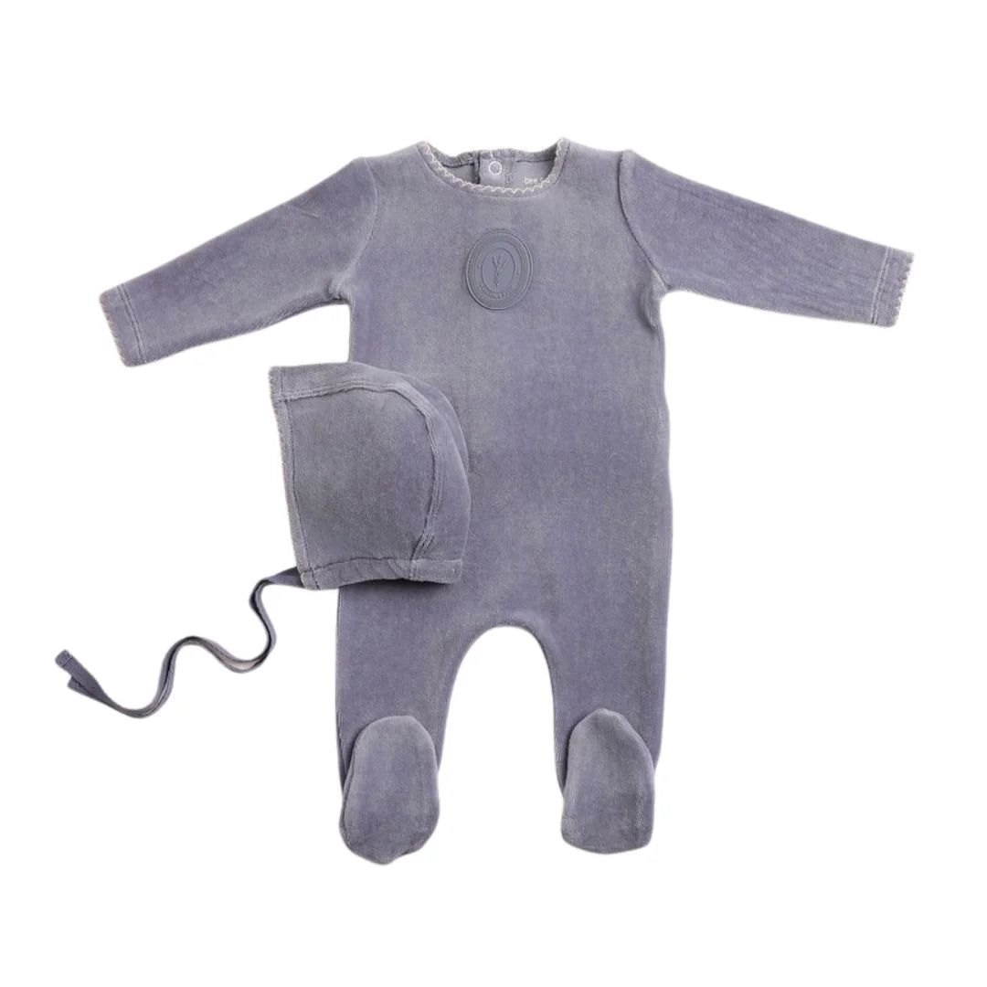A front view of the luxurious nightshadow blue Bee & Dee velour footie and bonnet set.
