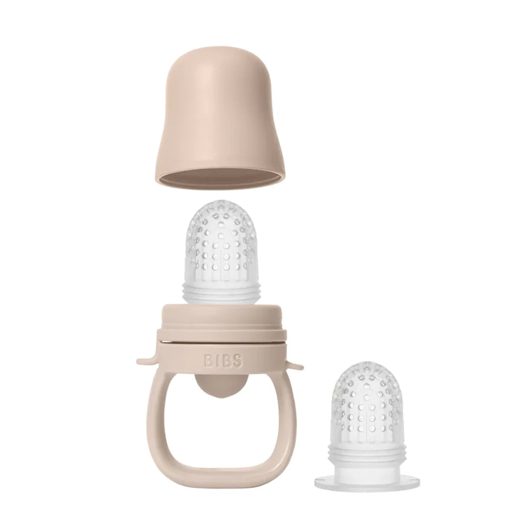 Baby teether with beige and clear components on a white background