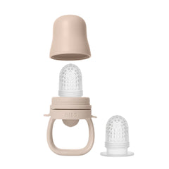 Baby teether with beige and clear components on a white background