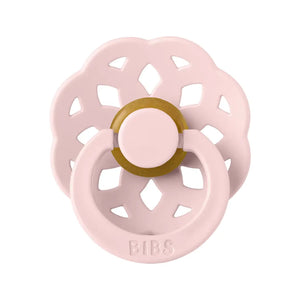 Pink baby pacifier with a gold ring on a white background