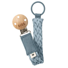 BIBS pacifier clip with wooden clip and textured blue strap on a white background