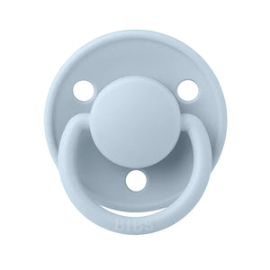 A breathtaking BIBS De Lux Silicone Pacifier in Baby Blue, showcasing its immaculate minimalist shield and premium clear silicone nipple.