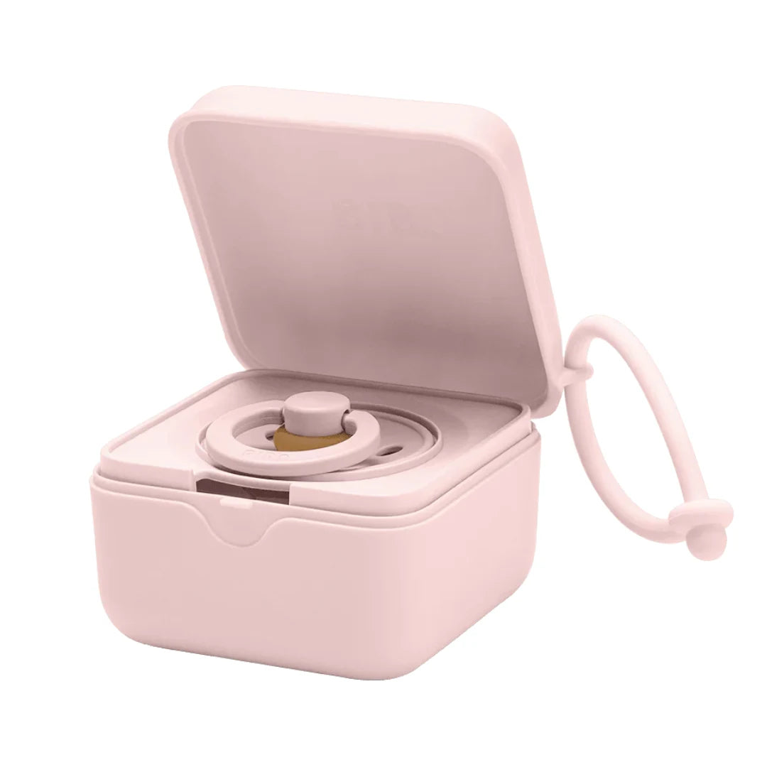 Pink jewelry box with a ring inside on a white background