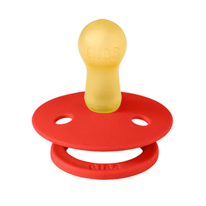 Red and yellow pacifier on a white background