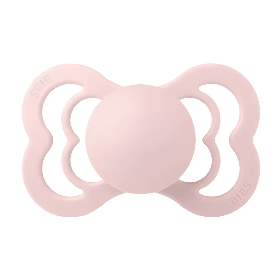 Pink BIBS baby pacifier on a white background