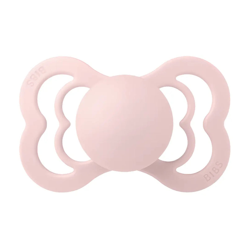Pink BIBS baby pacifier on a white background