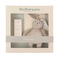 Bimbidreams baby gift set featuring a beige knitted bunny plush toy and a matching cream-colored bottle inside a cream-colored gift box with a clear window and a gray band.