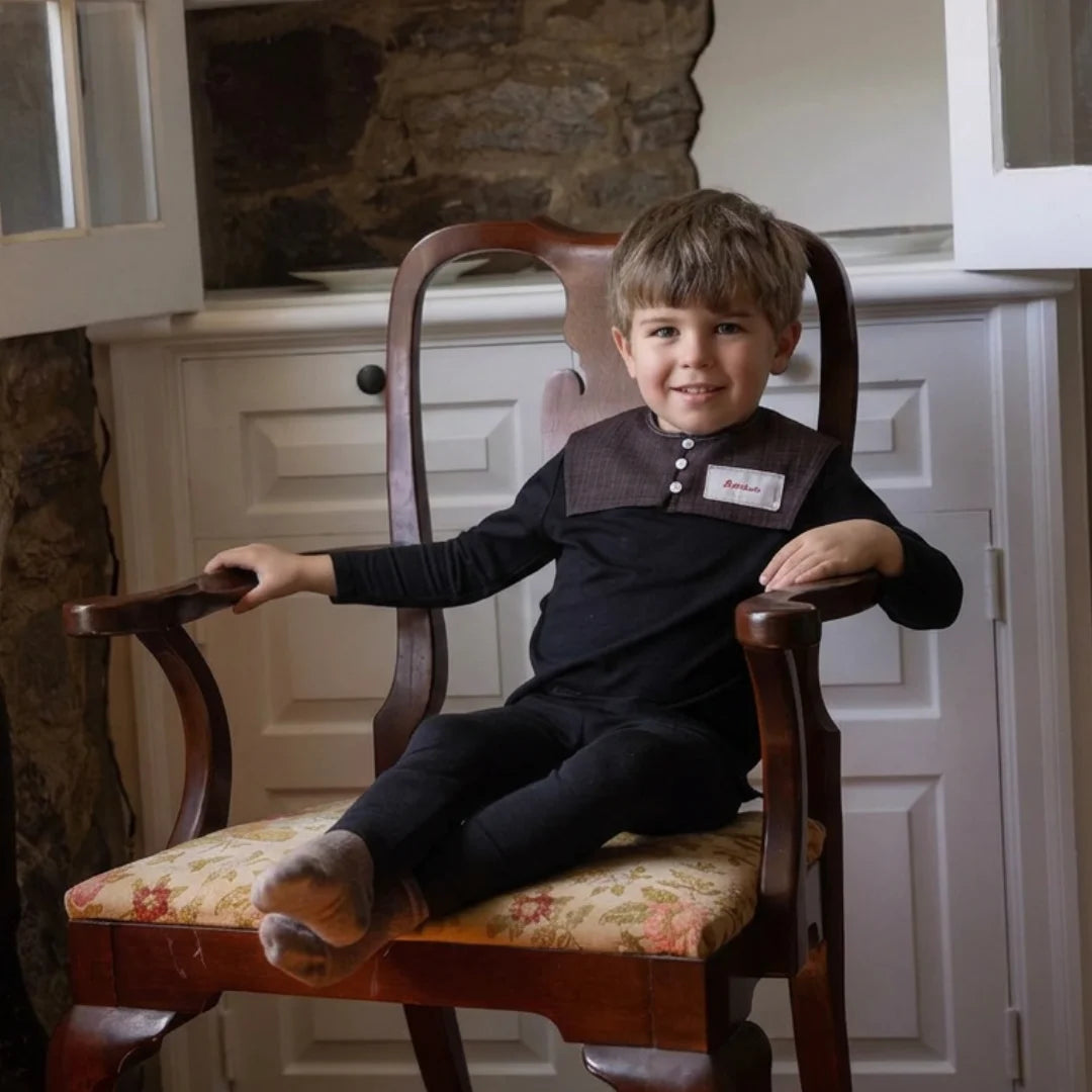 A young boy styled in the Bonjour black