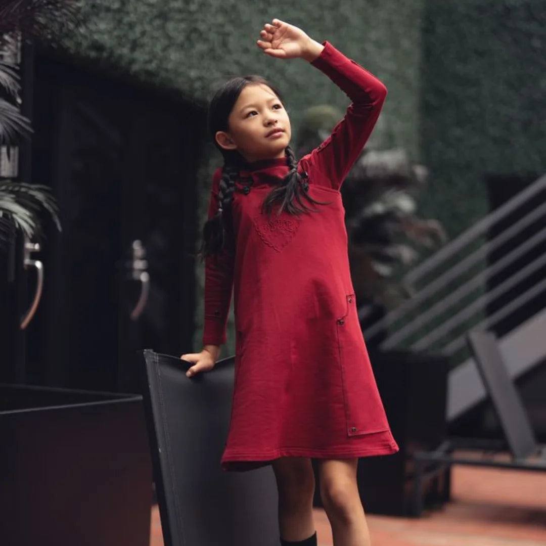 A person wearing the Byke cranberry patch jumper comfortably