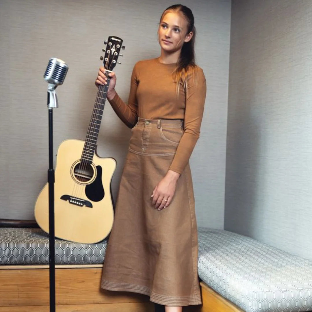 A person wearing the Byke Wash camel denim skirt comfortably