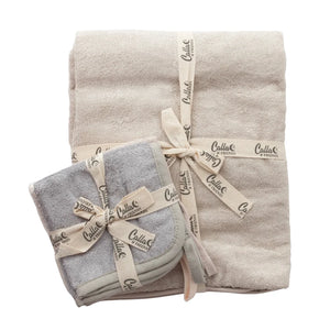 Two folded towels, one beige and one gray, with 'Calliope' branding on a white background.