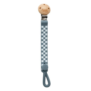 A breathtaking Calla & Friends Nash Everything Clip featuring an immaculate slate blue checkered pattern, designed to hold pacifiers and soothe teething gums.